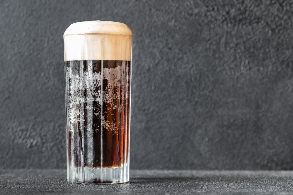 Glass of black velvet cocktail made from a combination of stout and champagne